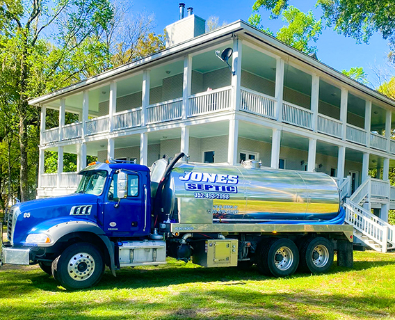 Jones septic truck in front of a multi-story home with wrap-around porch