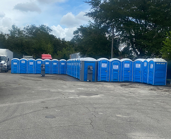 lots of blue Portable Restrooms in a parking lot